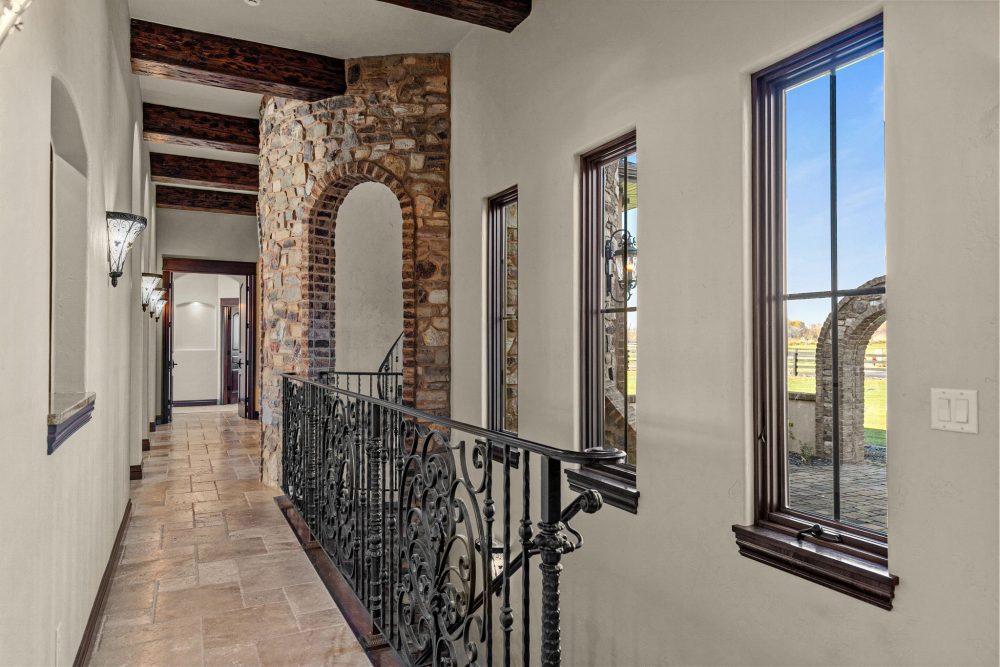 Grand hallway with custom steel/iron door, 19’ ceilings, Appleton WI estate