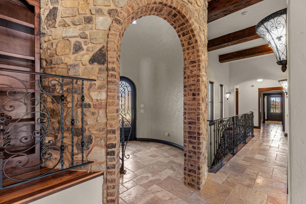 Grand entryway with custom steel/iron door, 19’ ceilings, Appleton WI estate