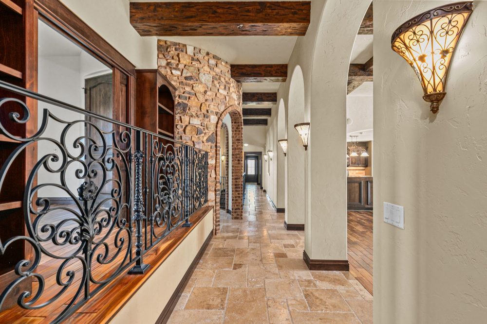 Luxury Appleton WI home hallway with knotty alder doors and iron railings