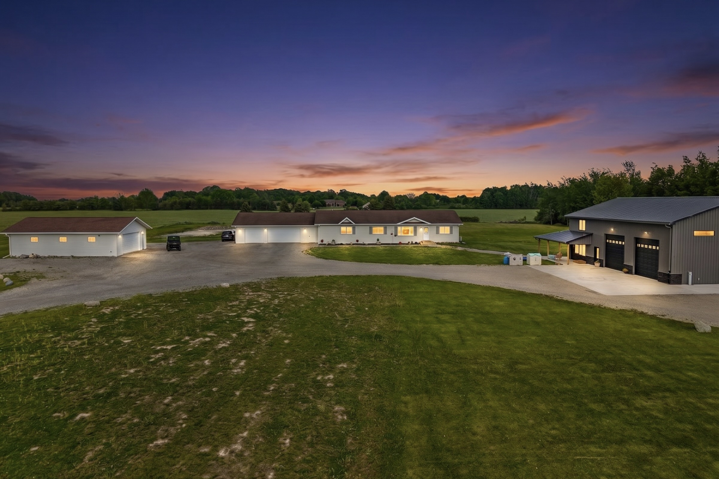 Twilight view of 1254 S Overland Road in Hobart WI with pond and outbuildings