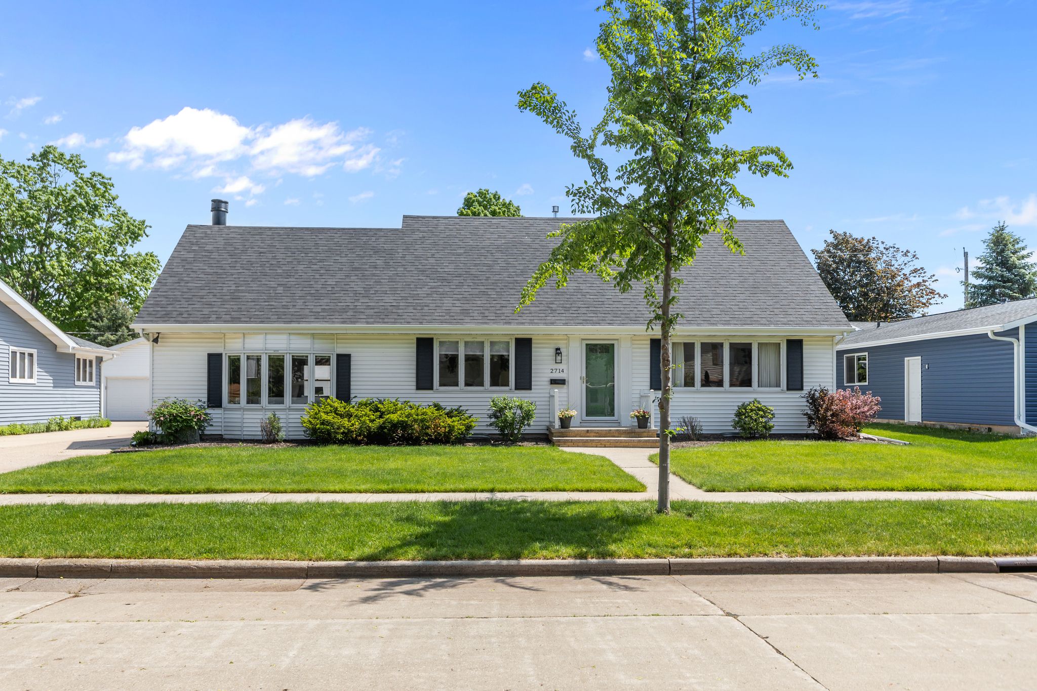 Front exterior of 2714 Elmwood Ct in Appleton, Wisconsin featuring exceptional curb appeal and a detached 2-car garage.