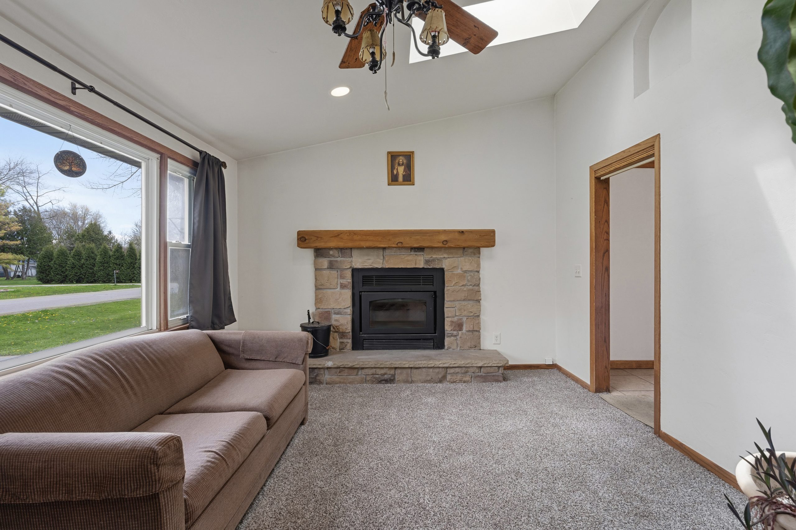 Living room with wood-burning fireplace at 607 Hunters Point Rd in Neenah Wisconsin